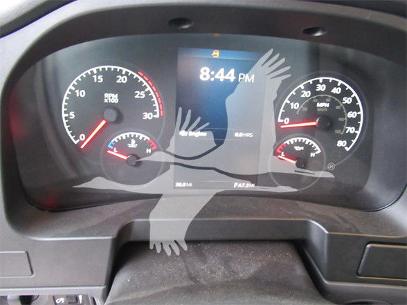 Kenworth T480 instrument cluster showing digital display 8:44 PM and analog gauges; left tach/engine speed, right speedometer, small gauges, reflection of hands