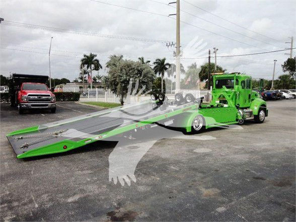 2022 Peterbilt 337 tow truck with a long green tow flatbed trailer and green cab. VIN 2NP2HM6XXNM762011, stock J62011.
