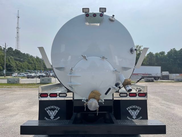 Back view of a 2013 Freightliner M2 sewer rodder truck with a large cylindrical tank mounted on a black bumper, Phoenix branding on mud flaps, rear lights, and hoses/connectors on the tank.