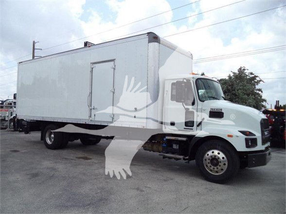 Box truck side view showing cab and large rectangular cargo box, Mack MD7 likely, with white exterior and wheel set visible.