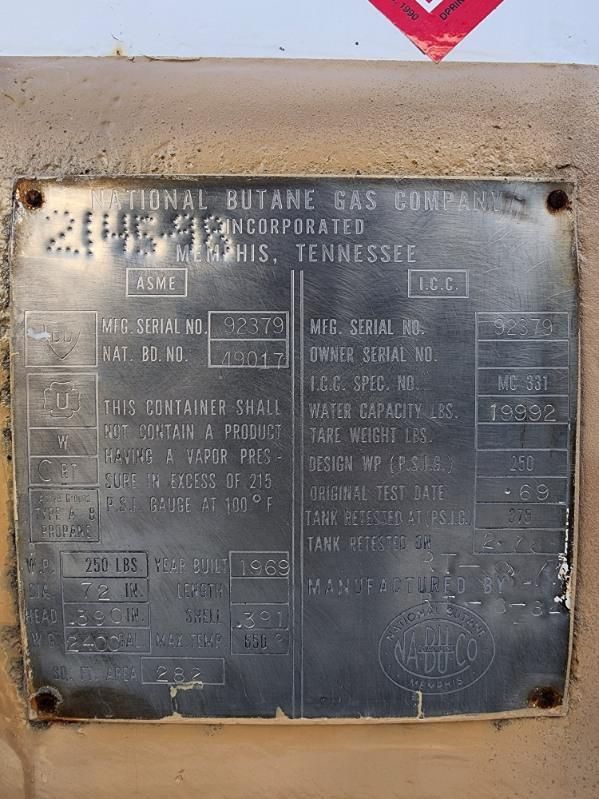 Metal data plate on a 1991 Chevrolet Kodiak truck showing manufacturer details such as National Butane Gas Company, Tennessee, serial numbers, water capacity, and tank specifications.