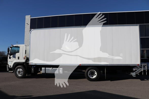 Isuzu box truck with trailer showing white dove watermark, cab on left, cargo box in center, text not legible.