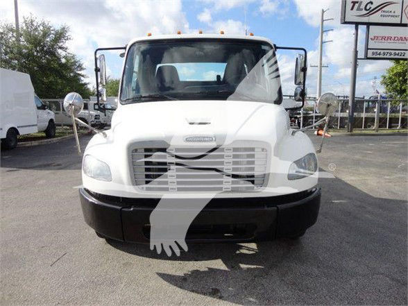 Front view of a white Freightliner BUSINESS CLASS M2 106 truck with large grille, headlights, side mirrors, and flat front bumper.