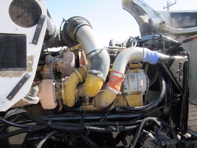 Kenworth T800 engine bay showing large intake hoses and turbocharger with yellow and orange silicone couplers.
