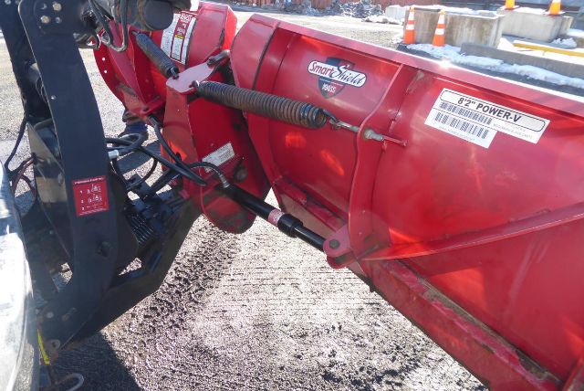 Red Smart Shield power take-off on a Chevrolet 2500HD truck body showing label 'Power-V' and hoses attached.