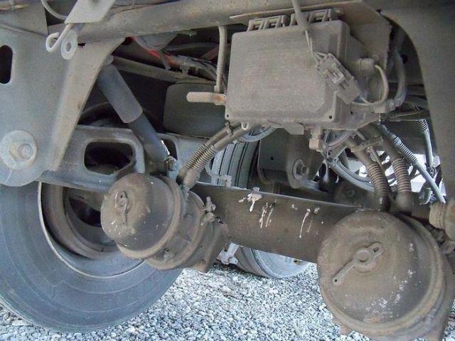Trailer axle underside showing suspension components and air hoses on Vanguard Dry Van VXP.