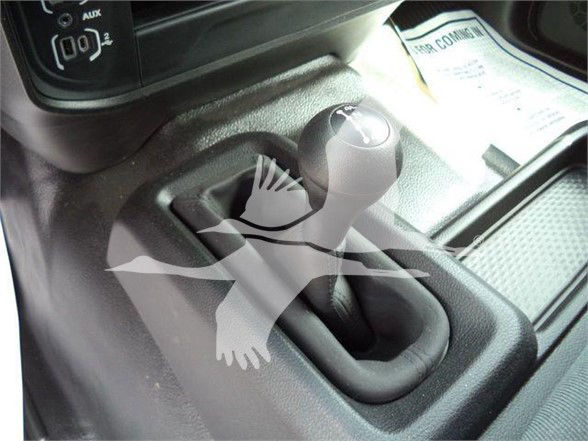 Interior gear selector and center console of a 2023 Ram 5500. Visible text includes 'AUX' and '02' near the shift area.
