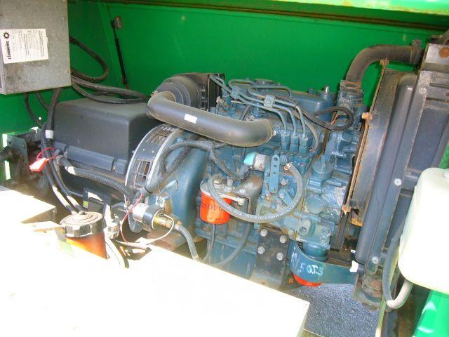 Trucking_equipment engine bay of a 2006 Terex AL4060D1-S-4MH showing blue diesel engine with hoses, belts, and orange oil filter cap.