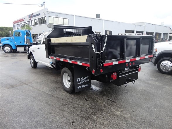 Ram 3500 dump truck rear and side view showing dump bed and chain anchor with black metal sides.