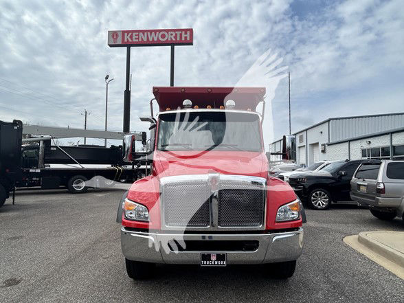 Front view of a red 2026 Kenworth T480 dump truck with chrome grille and Kenworth sign in background.