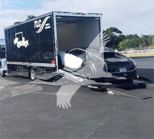 2022 Peterbilt 337 tow truck with a large black trailer attached, cab visible on the front, stock number J56602.