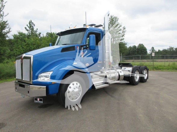 Blue Kenworth T880 conventional daycab tractor with chrome exhaust stacks and front grille, three axles, visible fuel tanks and tires.