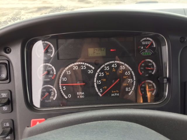Dashboard of a Freightliner 108SD cab showing multiple gauges and digital readout.