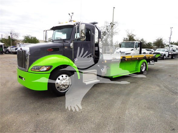 Peterbilt 337 tow truck with bright green front fenders and flatbed, side view