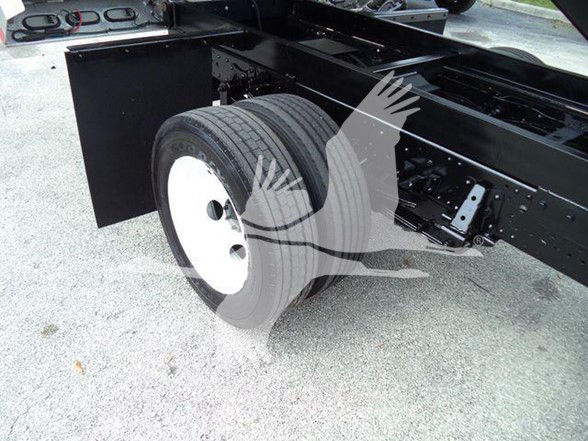 Truck chassis with dual rear wheels and black frame showing undercarriage and wheel assembly.