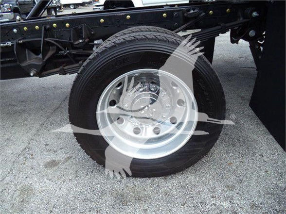 Ram 5500 truck wheel and suspension components visible in a truck chassis, steel rim with tire mounted.