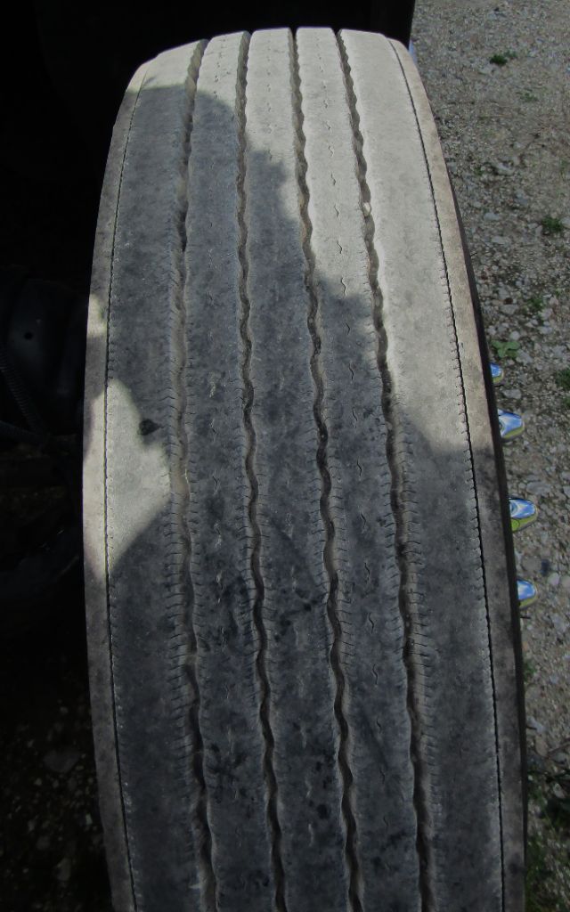 Tires on a Kenworth T680 cab and chassis showing worn tread and parallel grooves.