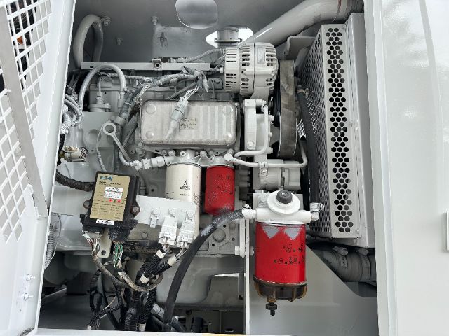 Peterbilt 340 engine bay with labels visible: power steering/ hydraulic lines, alternator, filters, and a red oil/air filter canister.