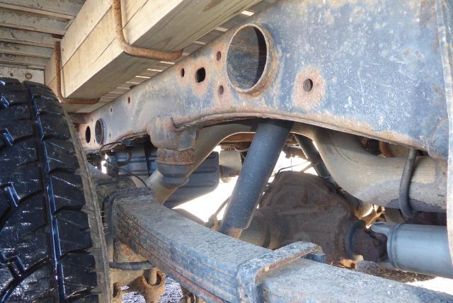 Chevrolet Silverado 2500HD chassis view showing front suspension and frame with leaf springs and tire.