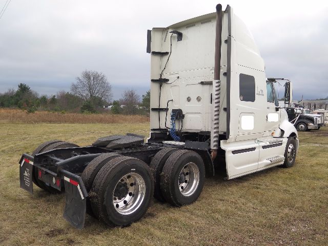 2010 International PROSTAR tractor cab showing rear view and dual rear axles with fifth wheel and exhaust stack.