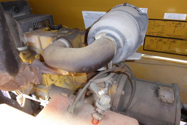 Allmand Night Lite Pro engine compartment showing exhaust pipe, radiator/air intake housing and components.