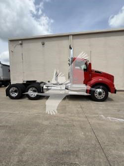 Kenworth T880 conventional daycab with a red cab and white box, side view showing chassis and wheels.