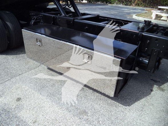 Toolbox mounted under truck bed showing metal diamond-plated case and latches.