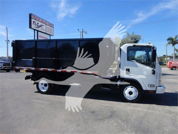 Isuzu NRR dump truck side view showing black dump body and white cab.