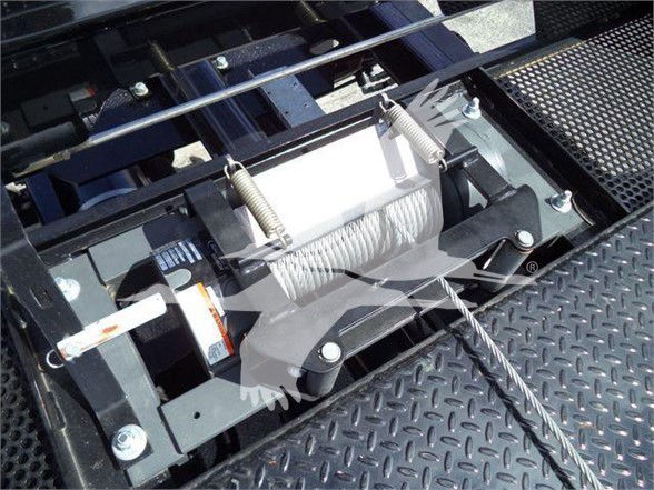 Tow truck—electric winch with steel cable on diamond-plate deck; visible winch drum and steel springs
