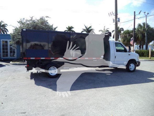 Ford E450 dump truck side view with blue dump bed and white cab.