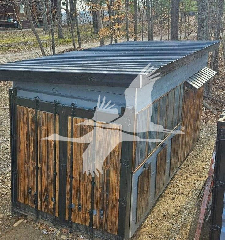 Newly built container trailer with vertical wooden siding, metal roof, and small window vent on the right side.