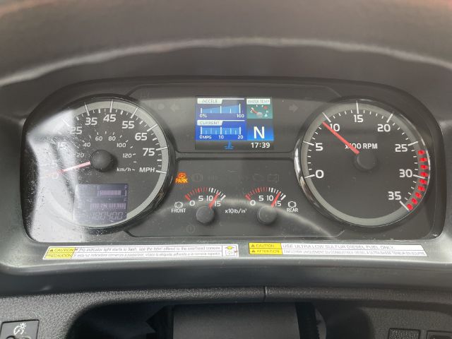 Dashboard of a 2017 Hino 268 box truck showing speedometer, tachometer, and central digital display with gear indicator and fuel/engine status icons.