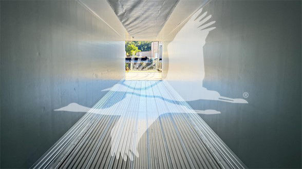 Trailer interior view down the cargo area with light at end; Vanguard Globe branding watermark overlaid.