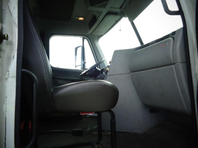 Cab interior of a 2009 Freightliner Columbia day cab showing driver's seat and passenger side dash.