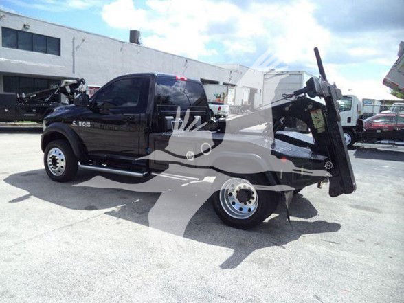 2018 Ram 4500 SLT tow truck with bed lift in black showing VIN and stock number not visible on the vehicle.
