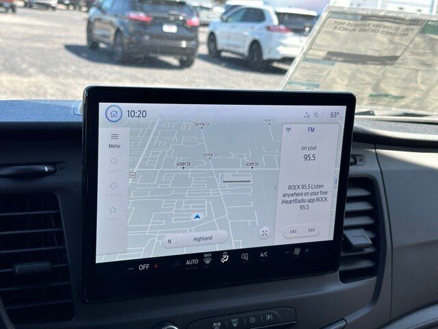 Ford Transit 350 box truck interior showing large touchscreen navigation display with map and radio info.
