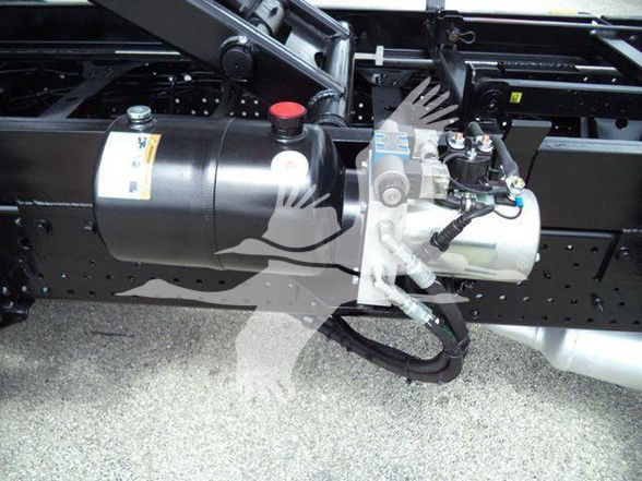 Chevrolet W4500 truck underbody view showing reservoir and hydraulic components with wiring harnesses.