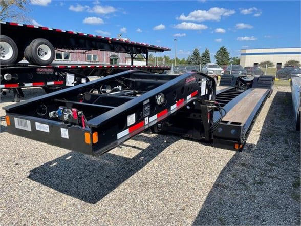  Fontaine 55 ton steel lowboy trailer with 26 ft deck showing hydraulic controls and painted black frame.