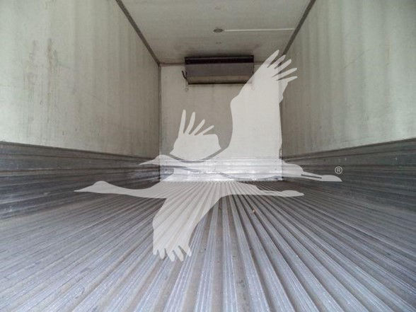 Truck Reefer trailer interior with ribbed floor and rear doors, empty cargo area.