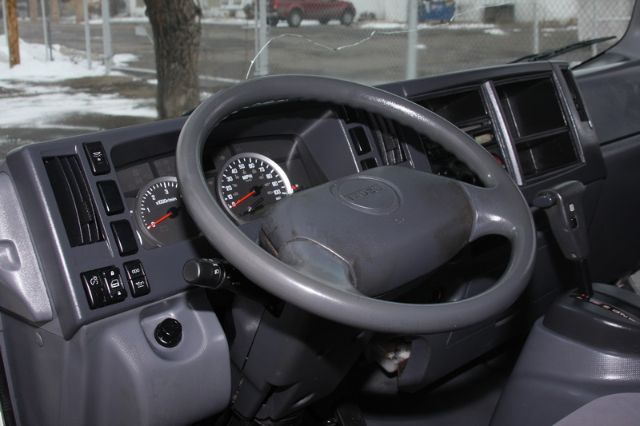 Isuzu NPR-HD truck dashboard with steering wheel and instrument cluster visible.