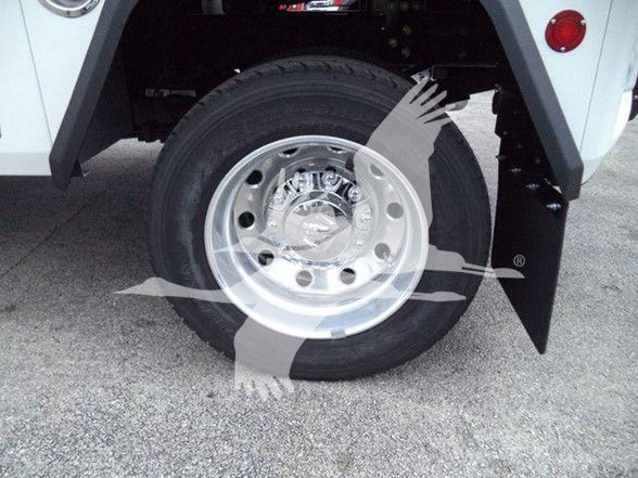 Wheel and front fender of a Ram 4500 tow truck showing a chrome wheel with black tire and part of mud flap.