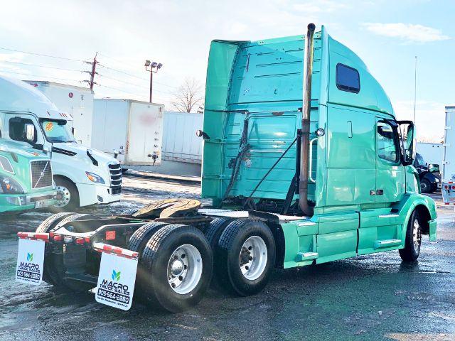 2015 Volvo VNL 670 tractor view from rear-left side showing sleeper cab, dual rear axles, and fifth-wheel area.