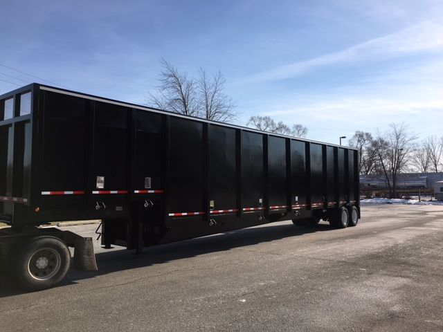 2002 Great Dane single-drop crush car carrier trailer in cargo black with multiple side panels and tandem axles.