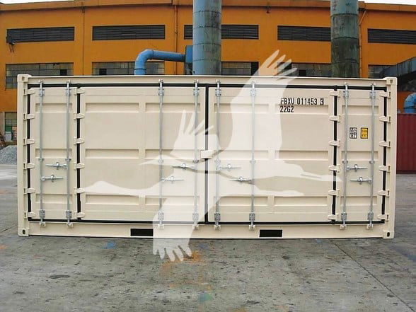 Container trailer door with locking bars and latches, beige color, yard background with orange buildings and blue pipes.