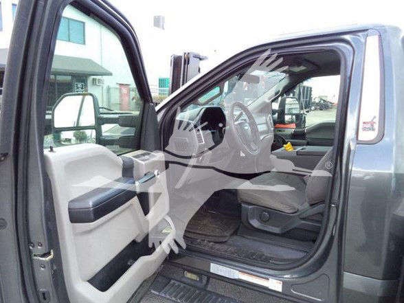 Ford F-450 interior front driver side view with open door showing dashboard and steering wheel.
