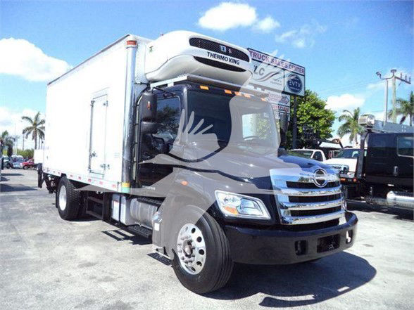Front-right view of a refrigerated box truck with Thermo King unit atop cab; visible text on the unit and truck.