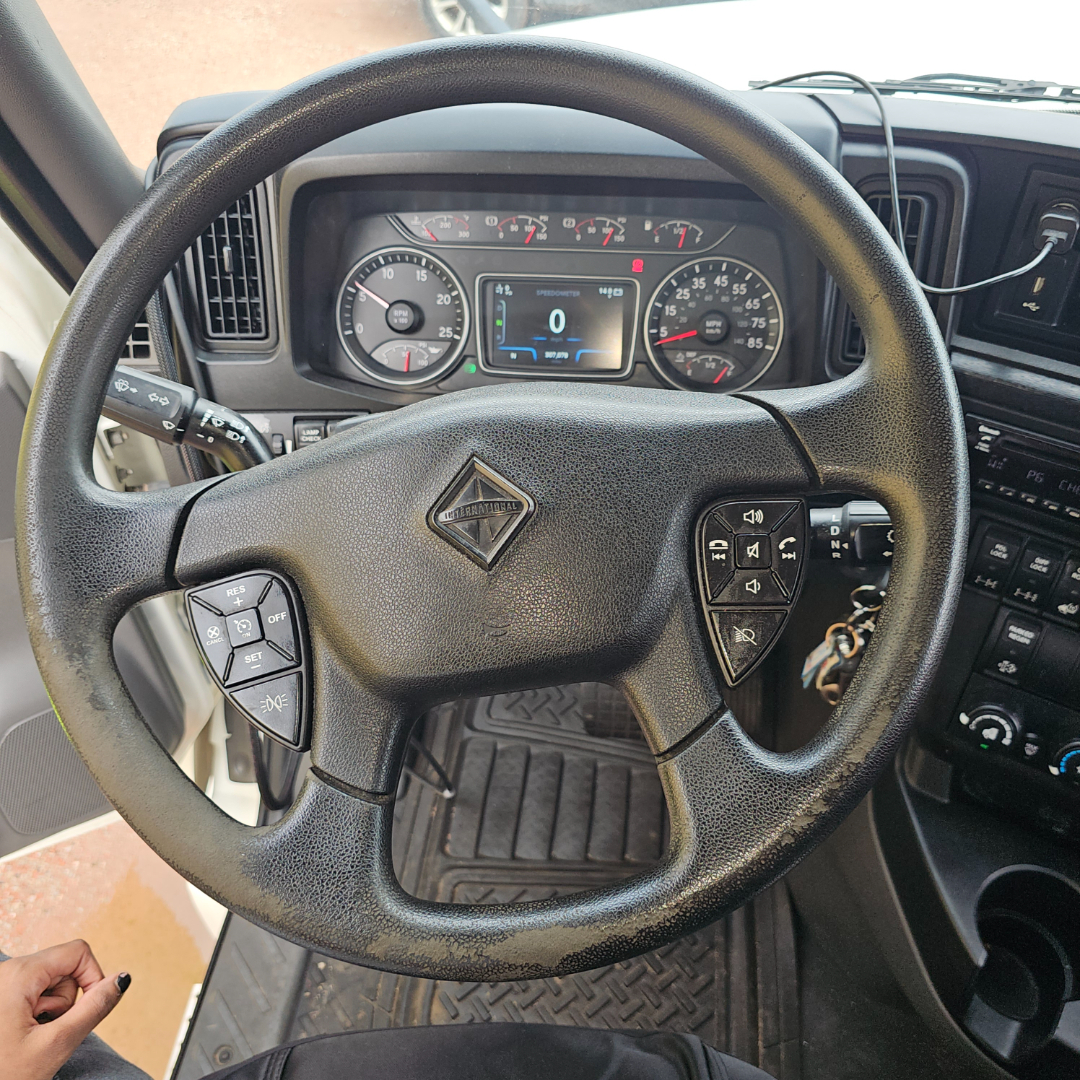Steering wheel and instrument cluster of a 2020 International LT daycab showing dashboard gauges and control buttons.