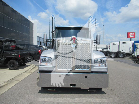 Kenworth W990 truck front view showing chrome grille, large bumper, dual vertical exhaust stacks, and rectangular headlights.