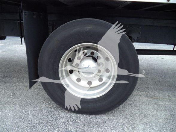 Wheel and tire on a Mack MD7 truck showing steel rim and tire sidewall.