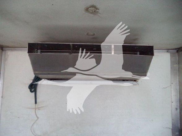 No visible labels or text due to overlay image watermark; interior refrigeration unit mounted in wall; power cord hanging.